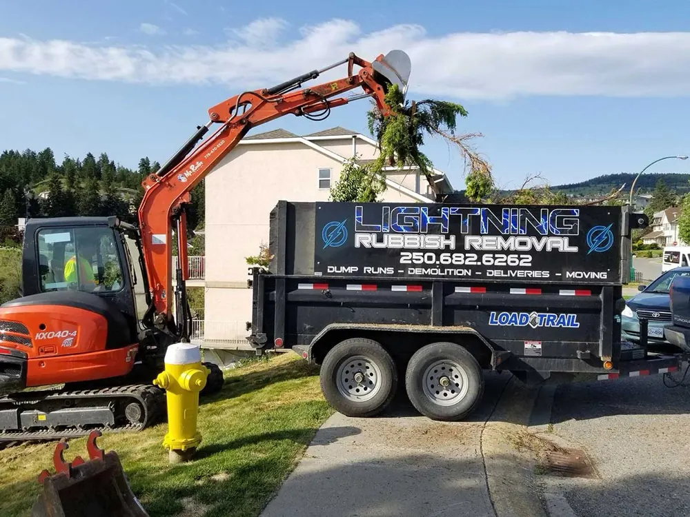 A Lightning Rubbish Removal bin being loaded by excavator on a Kamloops job