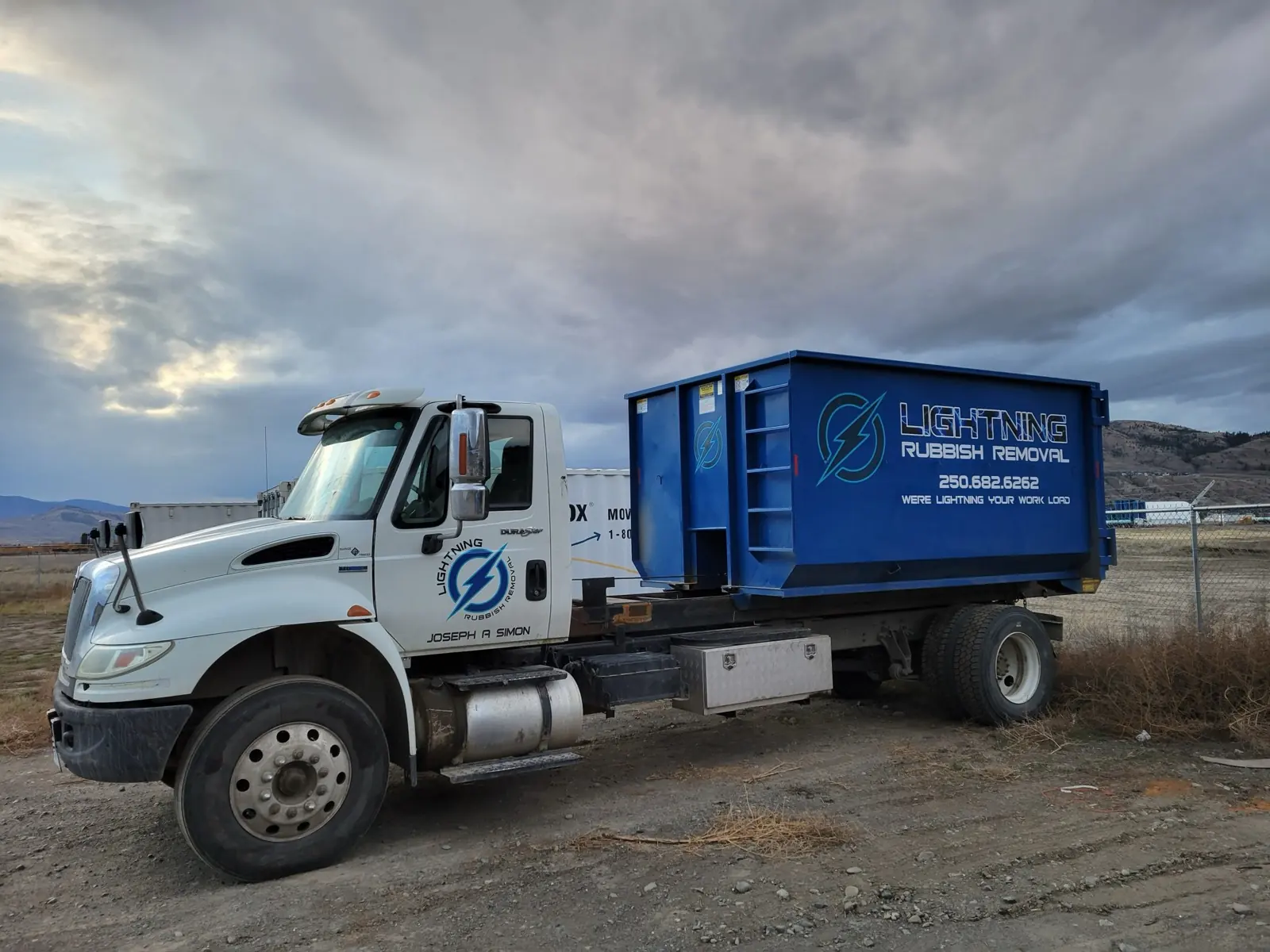 A Lightning Rubbish Removal truck and roll-off bin in Kamloops